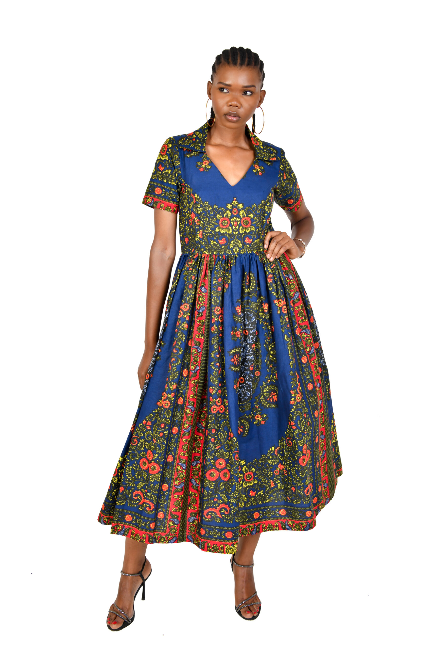 A woman wearing a vibrant V-neck midi dress with half sleeves in a bold African print, embodying elegance.