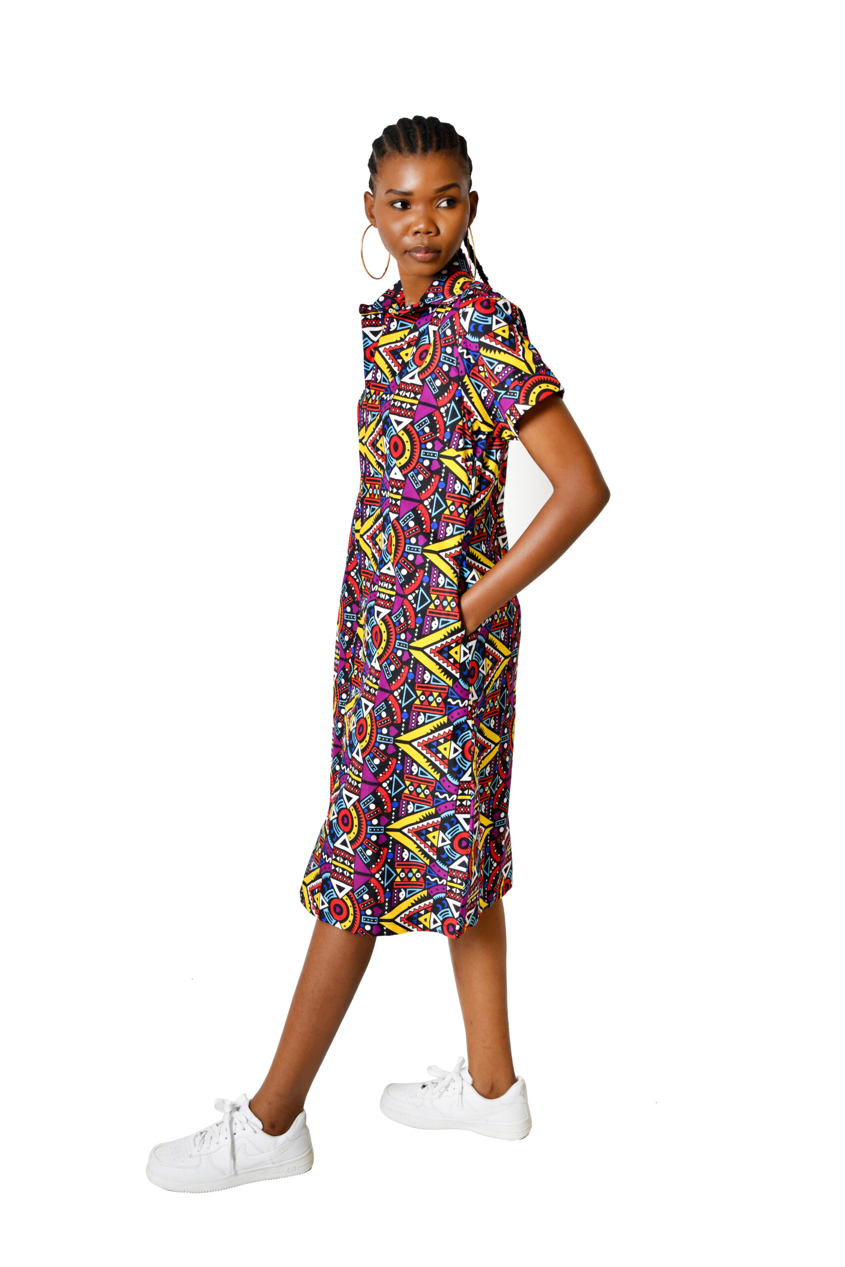 A woman confidently wearing a stylish Kitenge shirt dress, demonstrating modern African fashion.